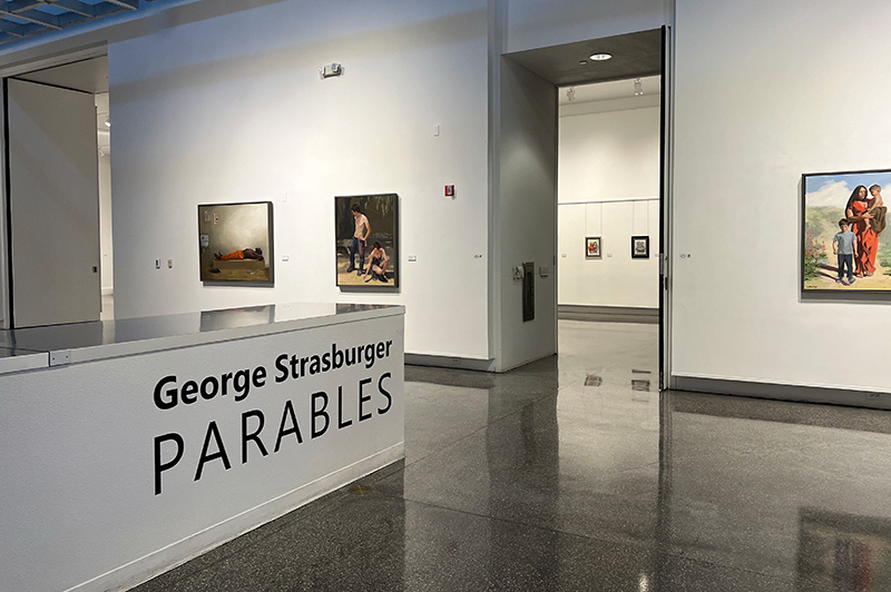 parables display at Sahara West library gallery, display sign in front, artworks showing in background