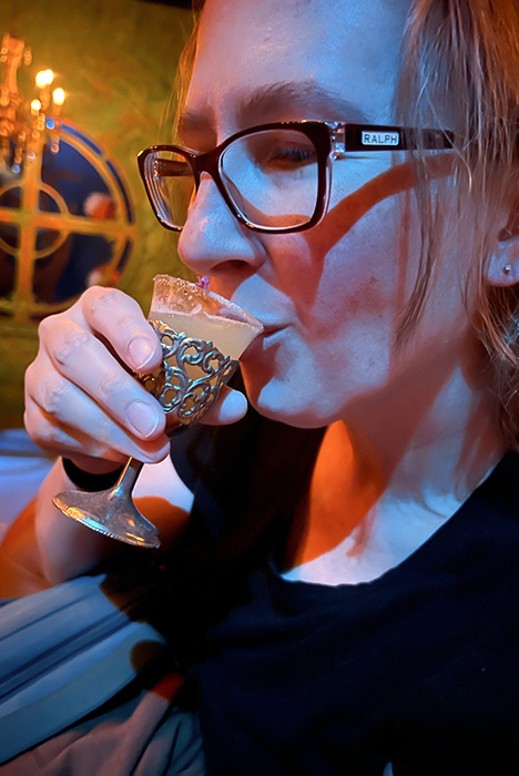 Shawna drinks the 20,000 Leagues welcome cocktail at Lost Spirits Distillery.