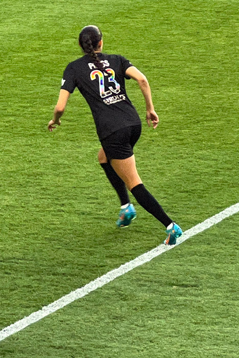 Christen Press wears a Pride jersey at ACFC's first Pride night.