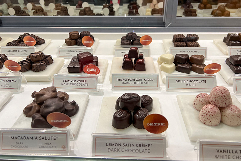 A variety of chocolates fill the display case at Ethel M Chocolates.