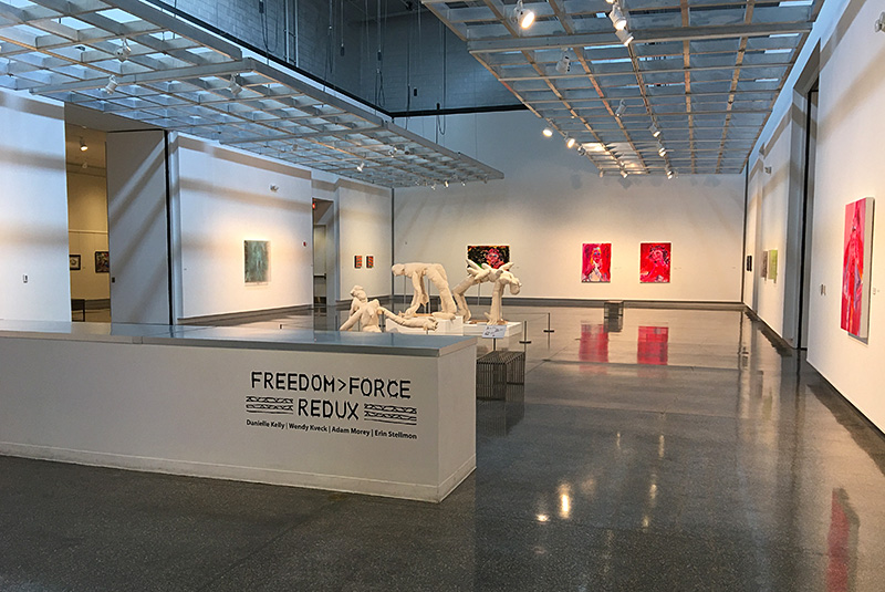 Freedom Force Redux display at the library, name of display in front, artwork in back