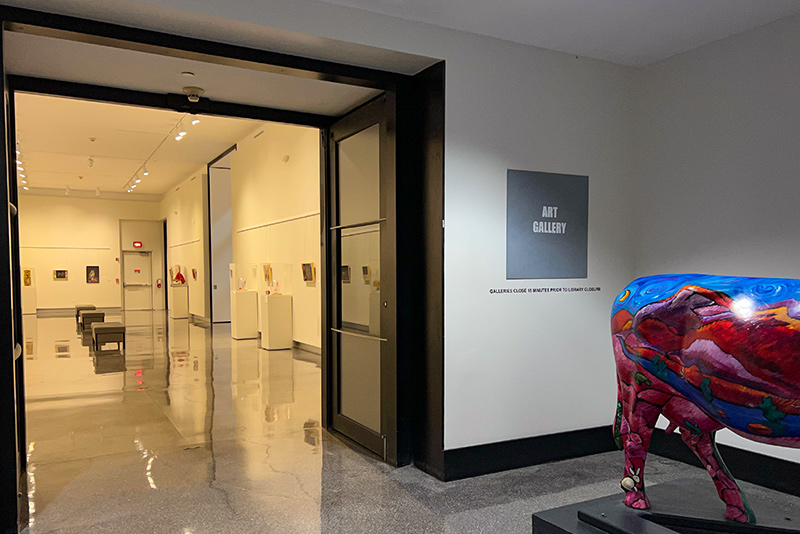 entrance to art gallery in front with gallery displays through the doorway