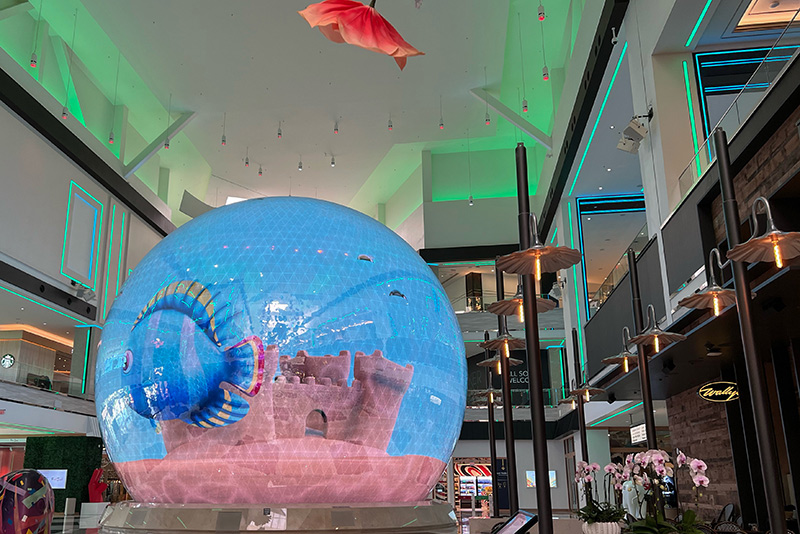 a large globe that display 3D images sits in the center of Resorts World shopping area